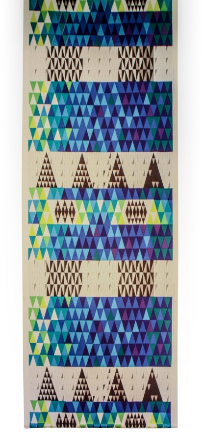 This textile is a woven and printed cotton drapery fabric. It includes repeating bands of small triangles in brown, shades of blue, shades of green, yellow, and white.