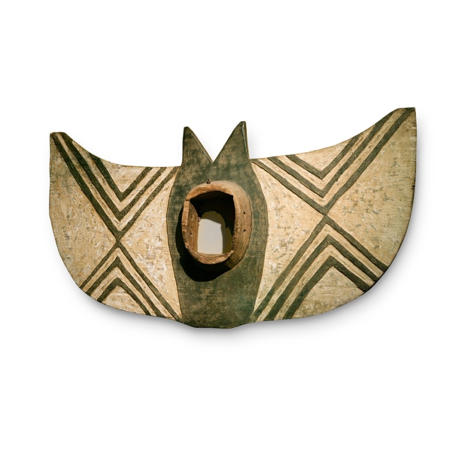 This mask is very large. The wingspan on this carved wooden butterfly mask is five and a half feet. The design is a simple concentric inverted triangles which breaks up the horizontal plane.