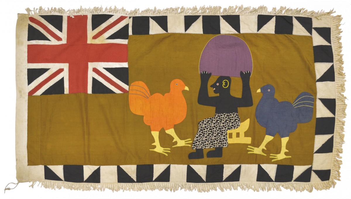 Depicted on this textile is a male figure seated on a king’s stool holding a large fan. There are also two large birds on either side of him which may represent members of the company. This flag also contains a large Union Jack and a graphic black and white border composed of alternating squares and triangles.