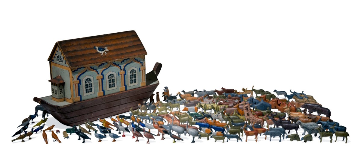 This Ark has over 200 animals made in the Alpine region of Germany, which has been a center of wooden toy making for several hundred years. This ark was made in a small factory, and has an access panel so the animals can be stored inside. The dove with an olive branch in its beak on the roof of the houseboat is a reference to the story of Noah.