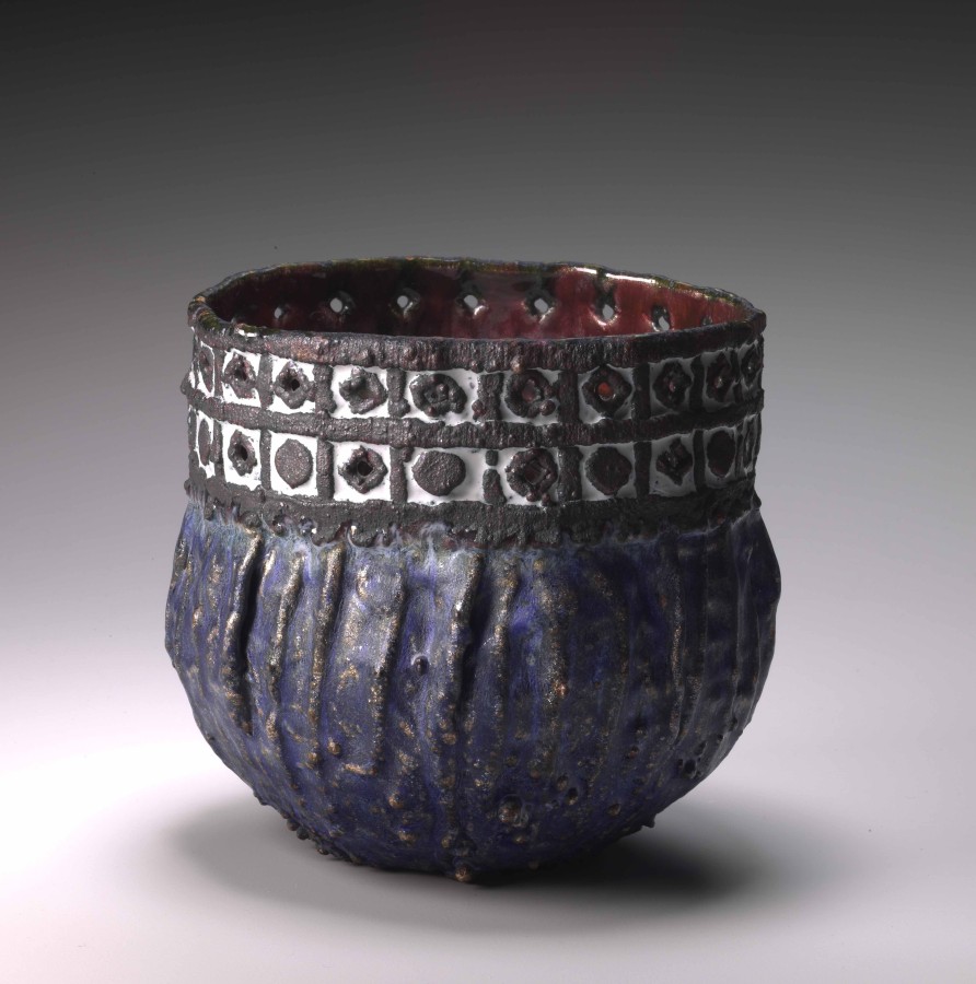 Vessel #561, June Schwarcz, 1970, California, U.S.A., electroformed copper foil with pierced and electroformeddesign, enameled red interior, blue and white enamel on exterior. Collection Mingei International Museum.