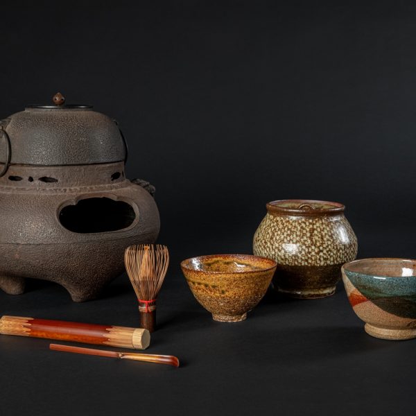 Objects for Japanese Matcha tea from Mingei International Museum's permanent collection. 

Image description: Various colorful tea instruments, including tea bowls, a water jar, chasen, matcha scoop, and brazier against a black background.